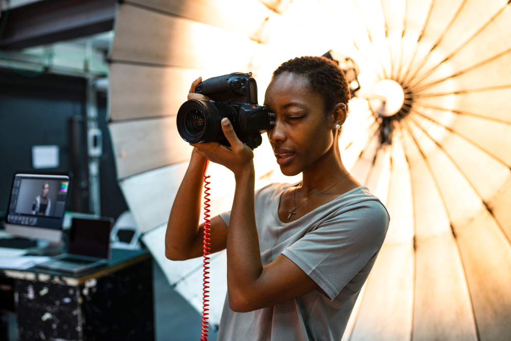 young,photographer,standing,in,front,of,a,reflective,umbrella, Freelance Photographers’ Credentials: 5 Simple Ways to Build Your Photography Resume, International Freelance Photographers Organization, IFPO, American Image Press, AI Press,photographer photo ID badge, press passes